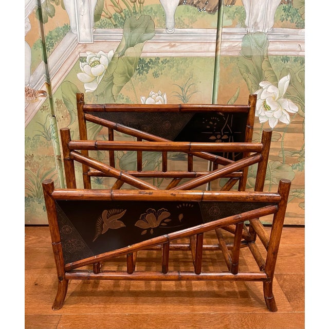 Rattan bamboo magazine holder. Two sections to hold magazines. Black lacquer detailing with birds and flowers.