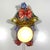 Very special ceramic wall lamp, Italy. Ceramic colorful clown that holds a flowerpot with light in it. Steel wall...