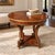 An elegant neoclassical Empire Revival round center table, attributed to Ethan Allen, featuring a richly figured sunburst...