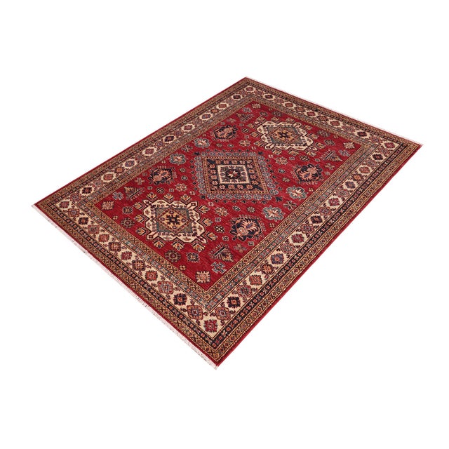 Enhance your home with this exquisite hand-knotted Super Kazak rug, crafted from fine hand-spun wool and dyed with all-...
