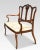Two seater mahogany settee, having three-part splat back to the upholstered seat enclosed by scrolling arms raised up on...