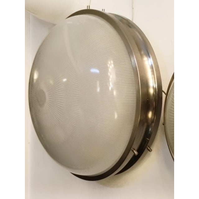 The “Sigma” wall lamp in nickel-plated brass and pressed glass, designed by Sergio Mazza in the 1960s for Artemide. The...