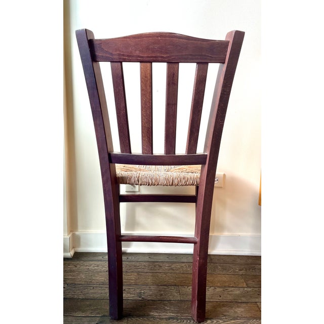 Stunning vintage Italian country dining chair featuring a rich brown beech wood frame and a natural, sturdy straw seat....