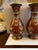 This pair of cloisonné enameled vases was created in Japan, mid-20th century. Each vase with elegant form features a gilt...