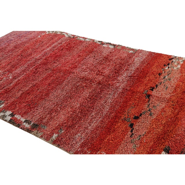 Hand-knotted in wool and originating from Morocco circa 1950-1960, this 6x10 vintage Moroccan rug is an extremely rare...