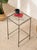 A streamlined vintage bar table with a tall, architectural metal frame and a square clear glass top. The slender...
