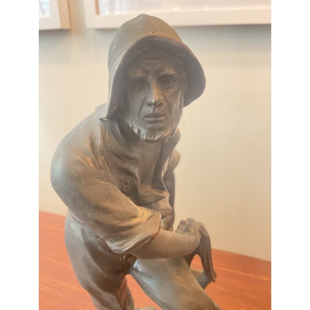 Lovely small bronze of a New England fisherman in original patina on marble base. Unsigned