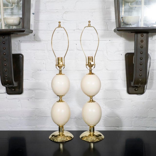 Pair of ostrich egg lamps with brass hardware in the style of Crespi.