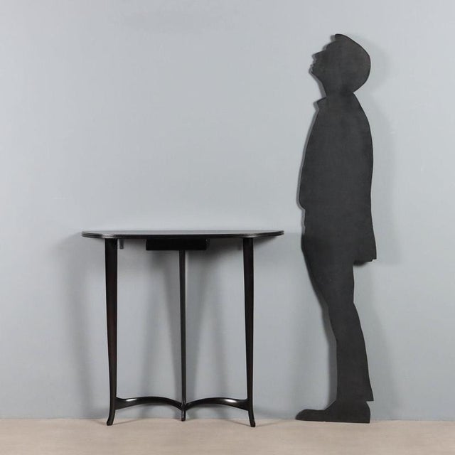 Elegant 20th-century Italian-made wall-mounted console table made of stained beech wood with a rounded top, a small...