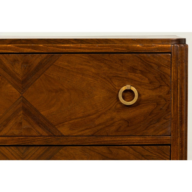 French Art Deco walnut commode by Mercier Frères, Paris, dating to the late 1920s or early 1930s. The three-drawer commode...