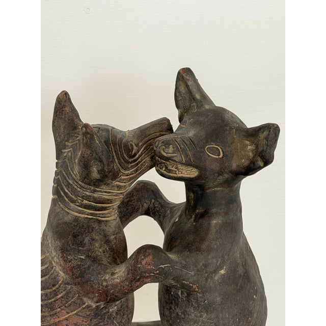 This vintage terracotta sculpture depicts a pair of dogs standing on their hind legs in the traditional Colima "dancing...
