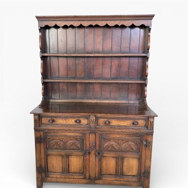 A substantial English Arts & Crafts oak kitchen pantry and display dresser by Christopher Pratt, showcasing beautifully...