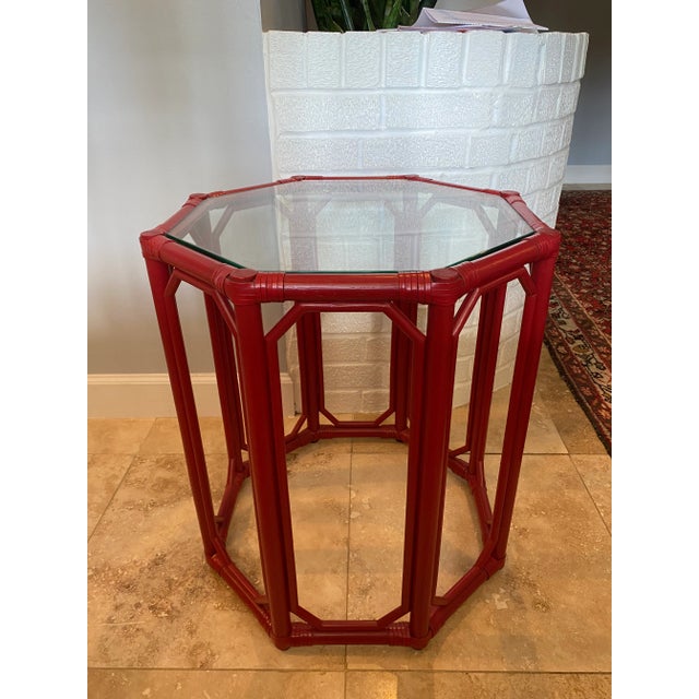 A brand new rattan and leather wrapped octagonal side table by Selamat. Color is “Antique Red” with a glass top that sits...