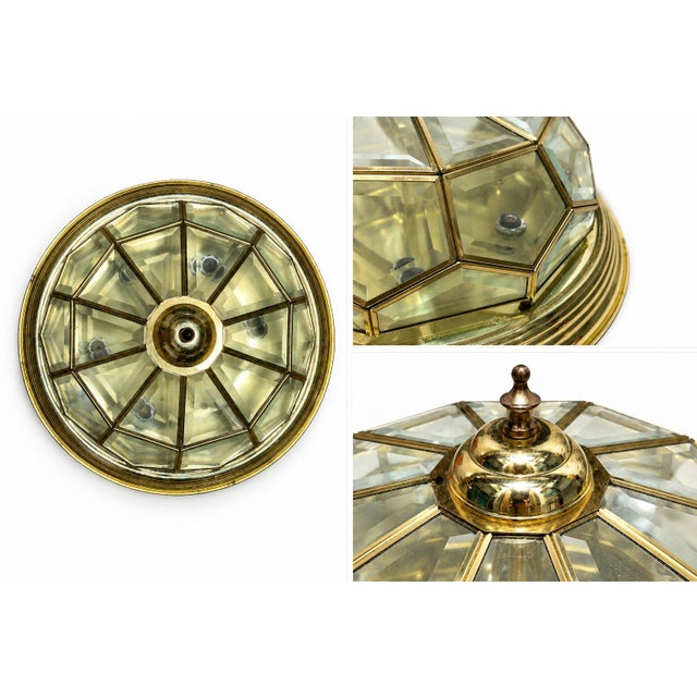 A beautiful vintage brass and glass ceiling light featuring a faceted geometric dome, warm aged brass framing, and a...