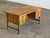 A danish oak pedestal writing desk designed by henning kjærnulf, bearing the original eg kvalitetsmøbel label on the...