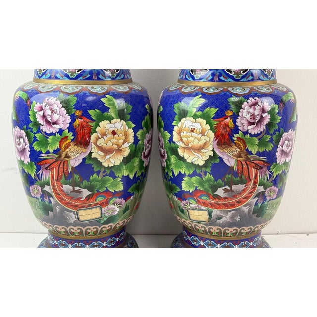Pair of Chinese cloisonne vases with gilt floral scrollwork, blue and green foliage, and purple blossoms on gold ground;...