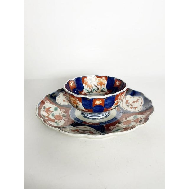 Japanese porcelain plate and bowl set dating from the 19th century. This decorative two-piece ensemble features...