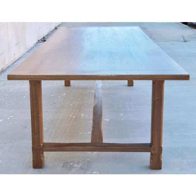 This table made from walnut has chamfered legs and fluted stretchers. It is seen here in 120" x 42"