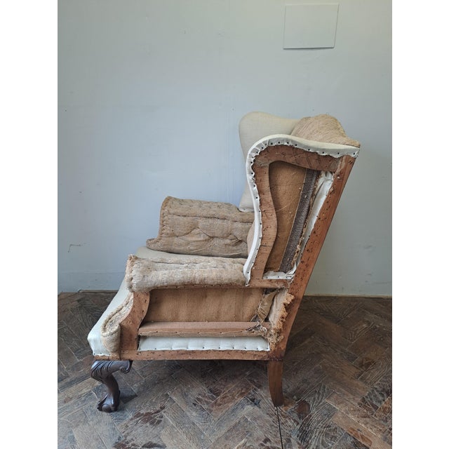 Hutton-Clarke Antiques is pleased to offer an Edwardian solid wingchair, ready for upholstery. This elegant piece stands...