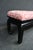 Asian-style bench featuring a black lacquered wood base with gently curved legs. The seat is upholstered in a pink...