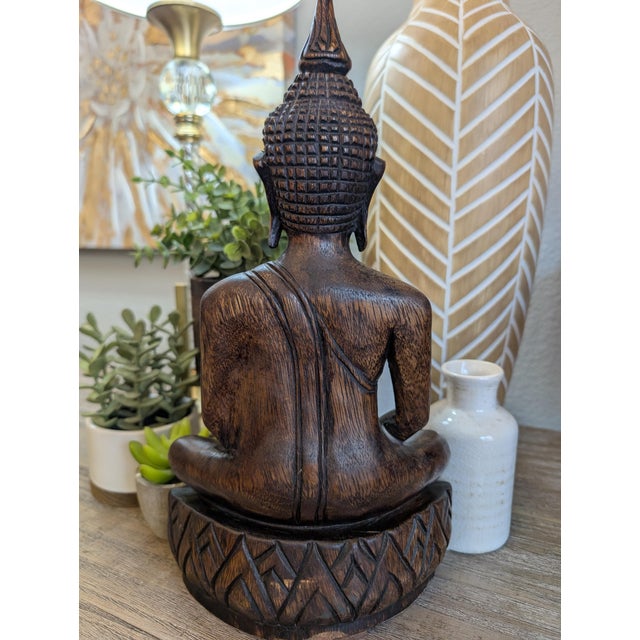 Beautiful vintage hand-carved wooden Buddha statue featuring intricate carved detailing and serene meditative pose. This...