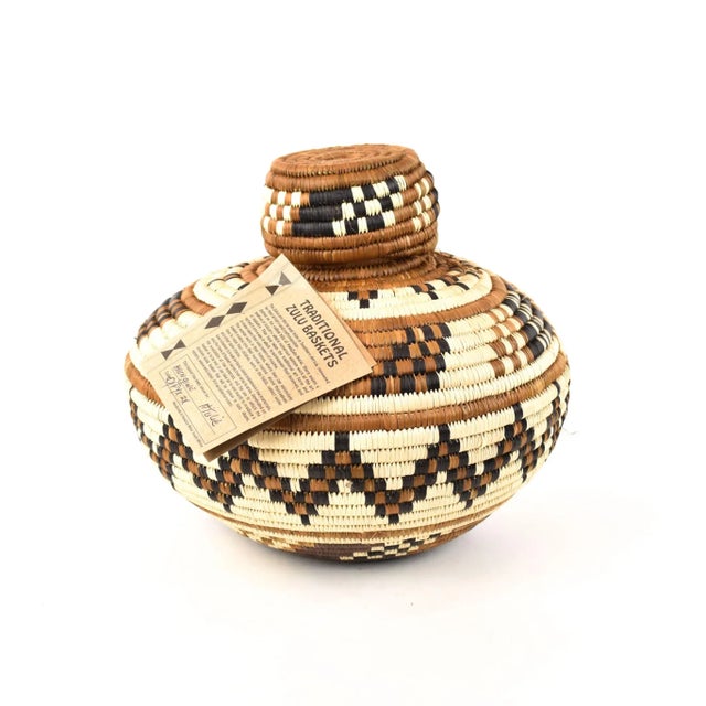 A basket handmade by the Zulu People in KwaZulu-Natal, South Africa. This isichumo basket was woven by Hiengiwe Ntulie....