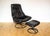 An ultra-comfy, rare and strikingly attractive Scandinavian black leather lounge chair and footstool in lovely vintage...