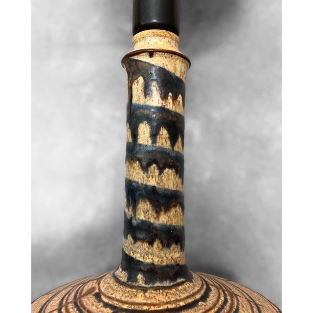 • Sculptural hand-decorated stoneware base • Graphic black and earthy glaze pattern • Distinctive tactile ceramic surface...