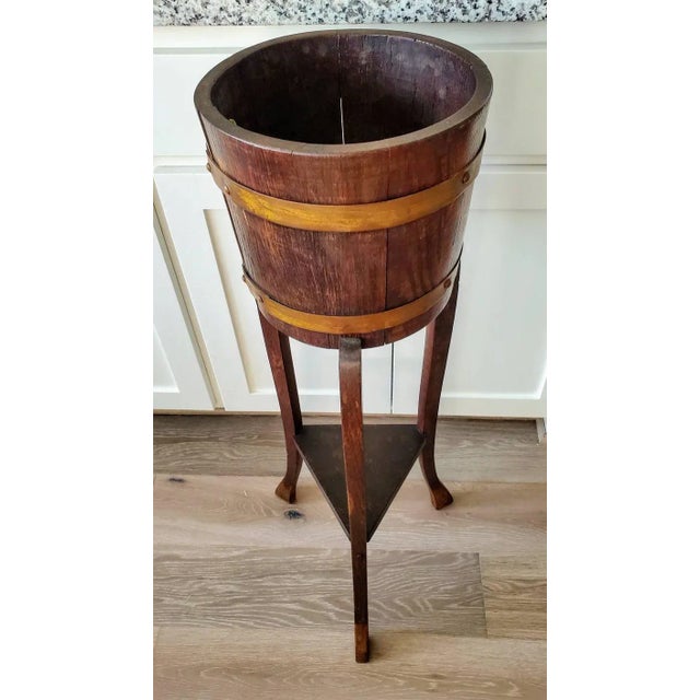 A very scarce English Edwardian period R.A Lister & Co. oak standing bucket from the early 20th century, having brass...