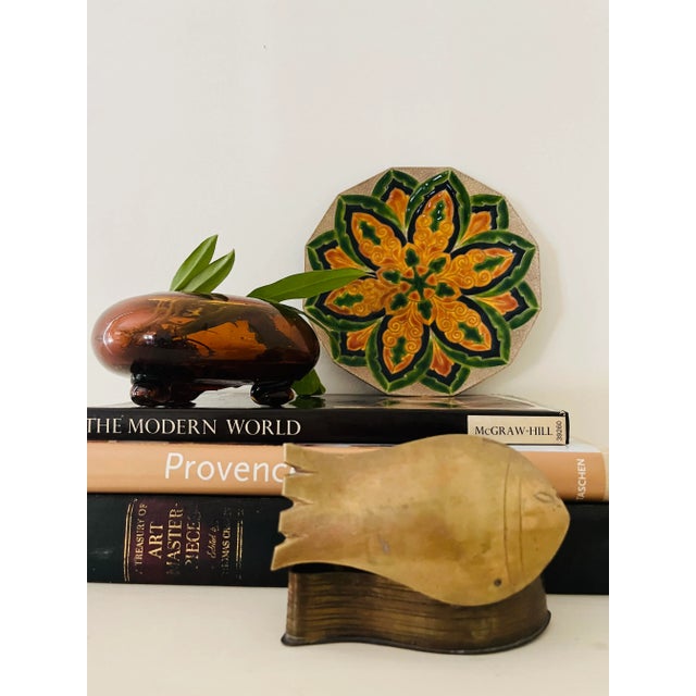 This mid-20th-century Italian enameled copper tray features a green and gold mandala design on a round copper base. The...