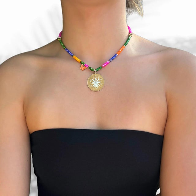 Wear the Spiritual Symbol Gold Pendant Colorful Beaded Necklace as a daily reminder of positivity, protection, and...
