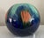 This beautiful vase is decorated like the northern lights in blues, greens, oranges. Shaped like a large globe, makes a...