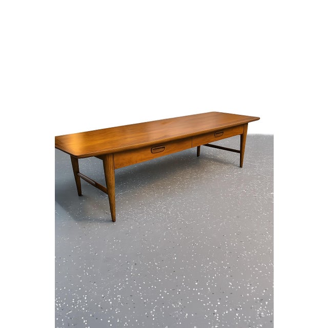 Beautifully preserved Mid-Century Modern walnut coffee table by Lane Furniture circa January 1960. It features the...