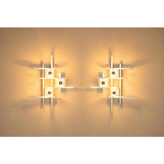 Italian lighting from the 1970s often balanced architectural clarity with decorative presence. These wall lamps by gaetano...