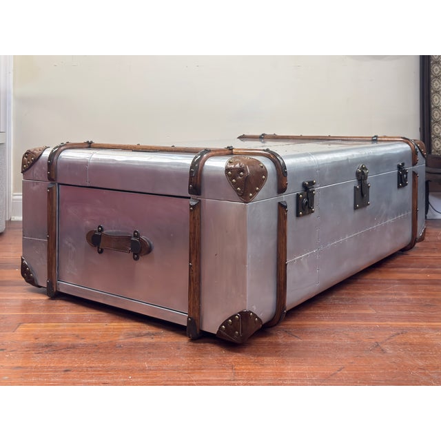 Coffee table is aluminum has a matte finish that's lightly distressed for a vintage look. Braced with strips of aged solid...