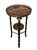 Distinctive vintage two-tier accent table dating to the late 20th century, featuring an exotic faux-bamboo metal frame...