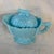The item is an antique Westmoreland blue milk glass grape and cherry patterned creamer pitcher featuring a matching lid...