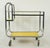 European Mid Century style bar or serving cart made of a chrome finished steel frame and two yellow and black trim Formica...