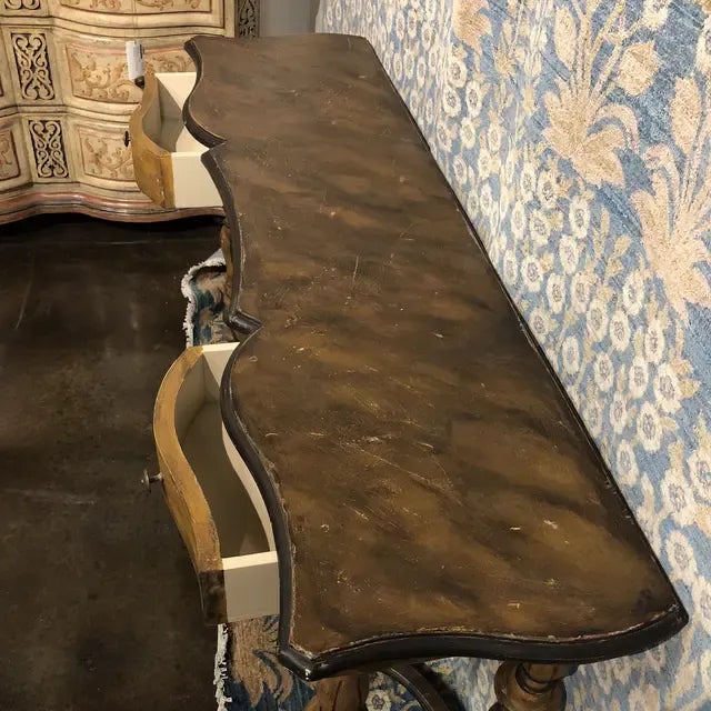 Hand carved wooden console table with two drawers, supported by turned legs and stretcher in a hand painted Vintage...