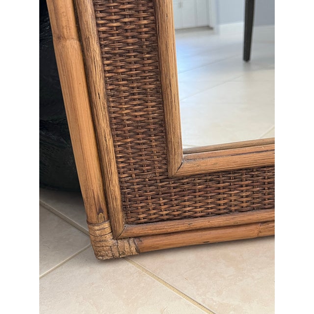 Large Bamboo Wall Mirror. The design combines a textured, woven inner border with a structured bamboo outer frame,...