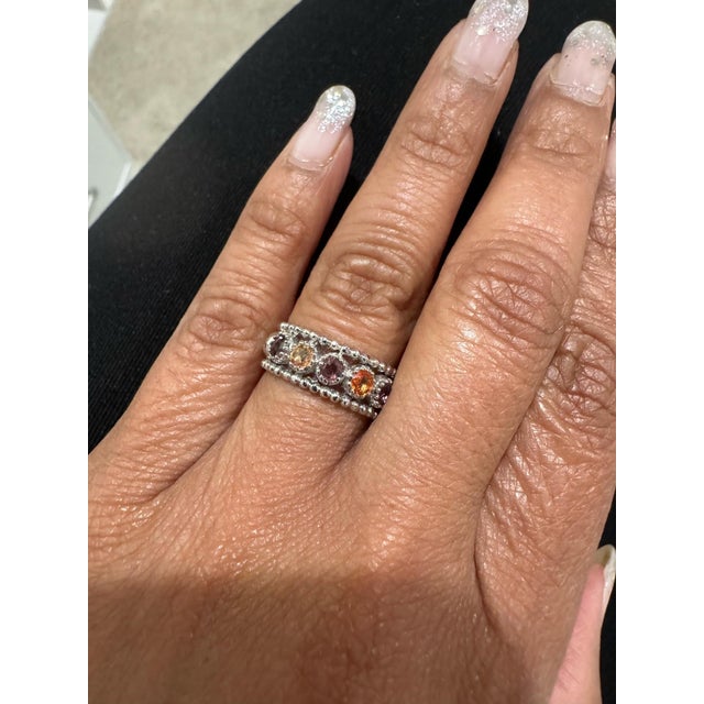 Simple sapphire band in 14K White Gold There are 6 Round Cut Natural Multicolor Sapphires with hues of Orange and Yellow...