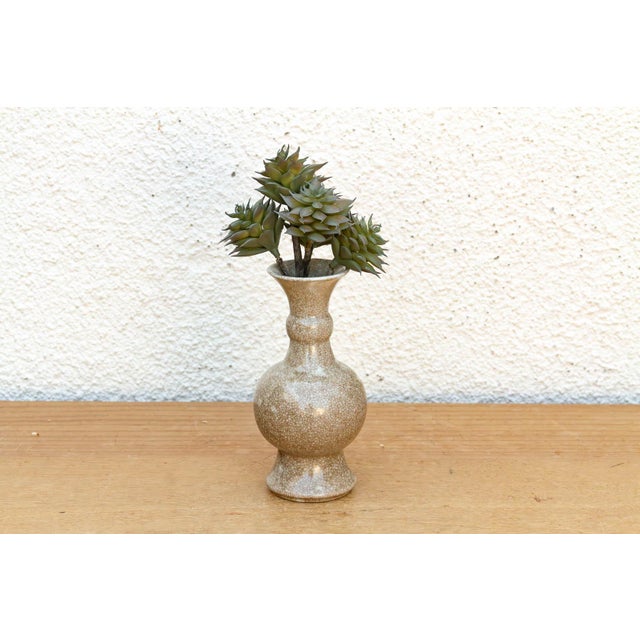 This vessel is a refined example of traditional ceramic work, featuring a classic double-gourd silhouette and a complex...