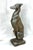 A graceful cast stone sculpture of a seated greyhound, mid 20th century, with a naturally aged surface and serene...