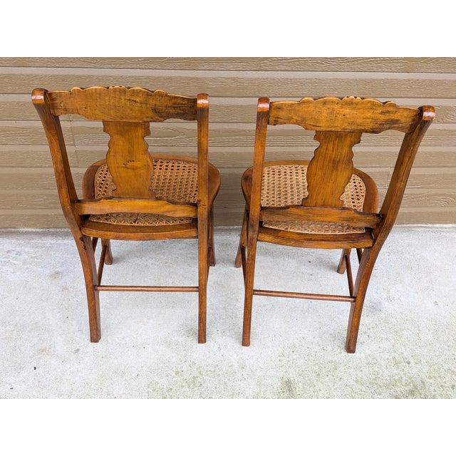 Two beautiful antique side chairs crafted from Birds Eye and tiger maple. Chairs feature hand caned seats. Sturdy and...