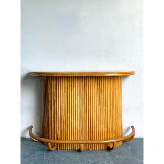 Infuse your entertaining space with the laid-back luxury of this vintage pencil reed rattan dry bar. This stunning piece...
