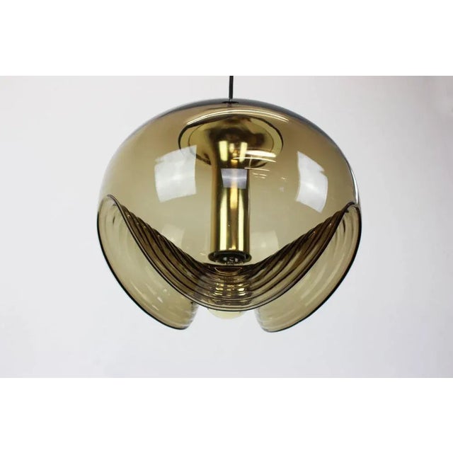 A special round biomorphic smoked glass pendant designed by koch & lowy for peill & putzler, manufactured in germany,...