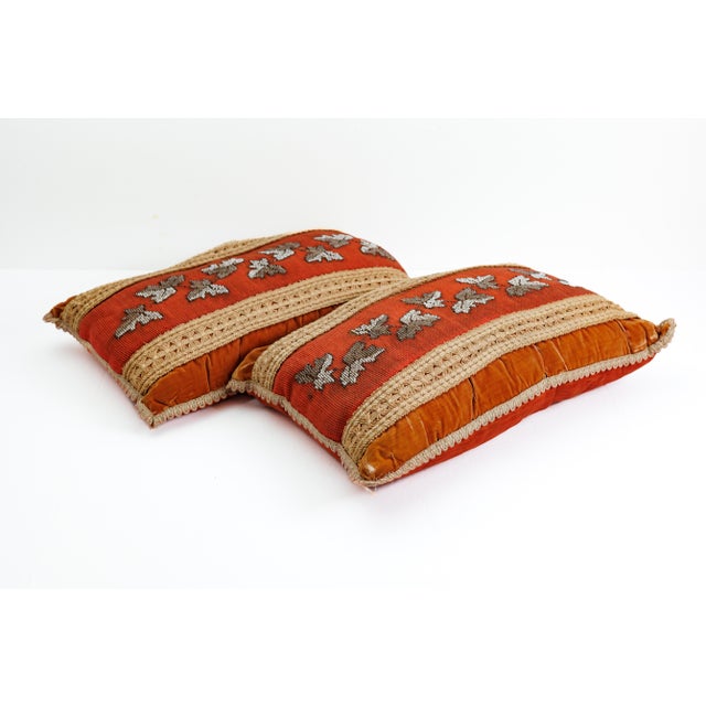 A sumptuous pair of Victorian-era lumbar pillows, each centered with a terracotta wool needlepoint panel worked with...