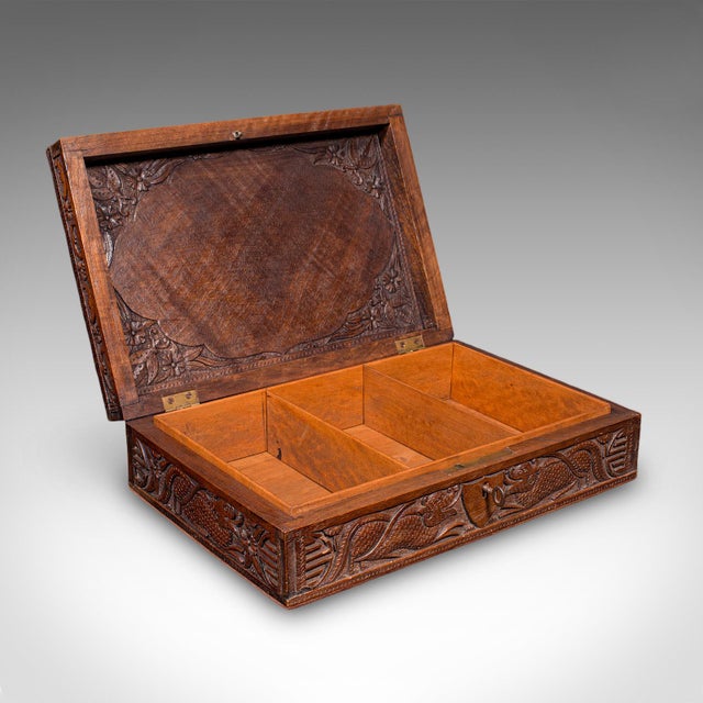 This is a vintage carved cigar box. An Oriental, teak keepsake or jewellery case with dragon motif, dating to the Art Deco...
