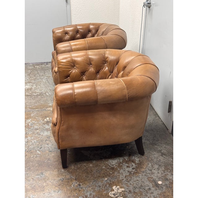 Design Plus Gallery presents a Pair of 1930's English Tufted Leather Tub Chairs from Restoration Hardware. Built for...