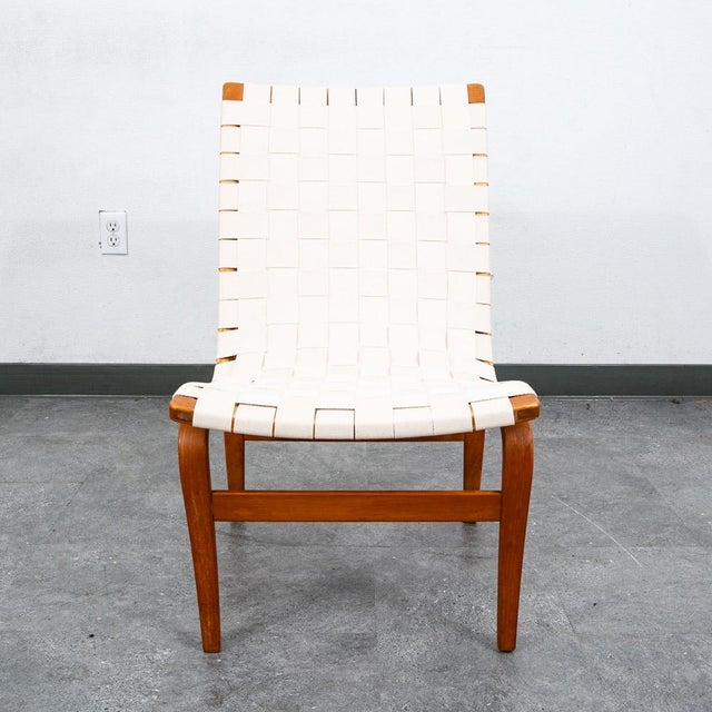 Iconic "Eva" chair designed by Bruno Mathsson. It comes with frame of molded beech stretched with thick interwoven canvas...